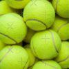 Lots Of Vibrant Tennis Balls In A Pile From A Hopper Tote Bag Official Tennis Merch